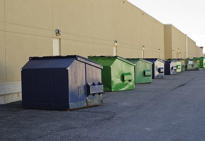 big yellow dumpsters on a construction lot in Alvin